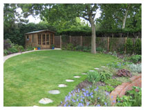 Stepping stone path, lawn for picnics shaded by oak tree, children’s playhouse.