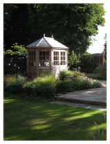 Planting which gives interest in all seasons surrounds this summerhouse which is used all year round.